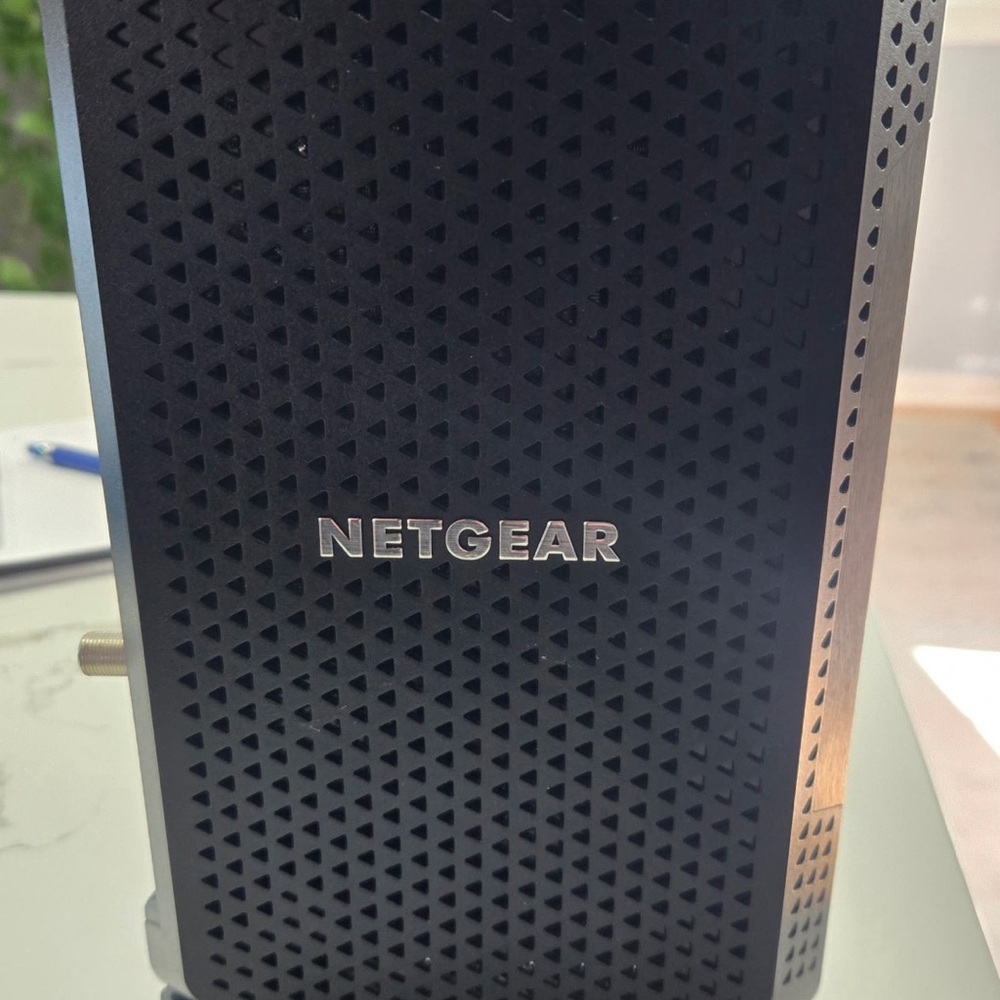Netgear Black Modem with Perforated Design and Vertical Tower